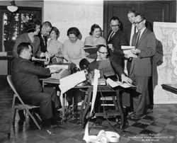Photo of Redistricting Committee working with adding machine